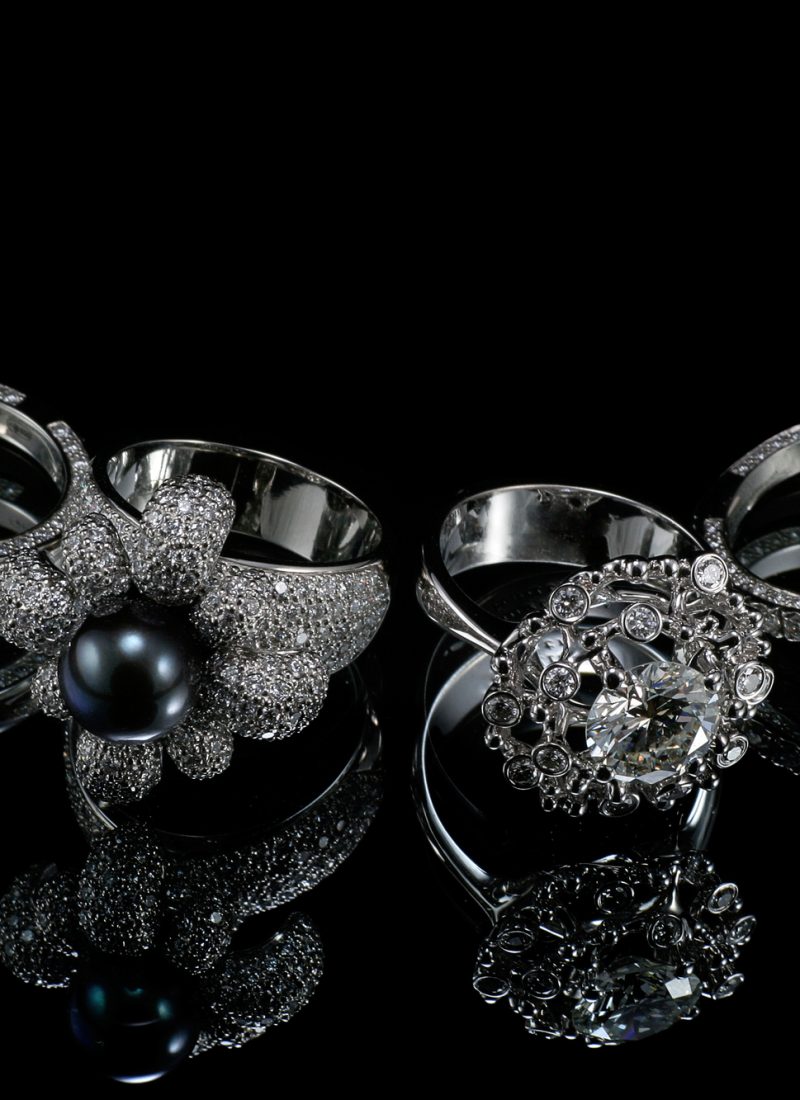Collectionsof rings with diamond isolated on black background